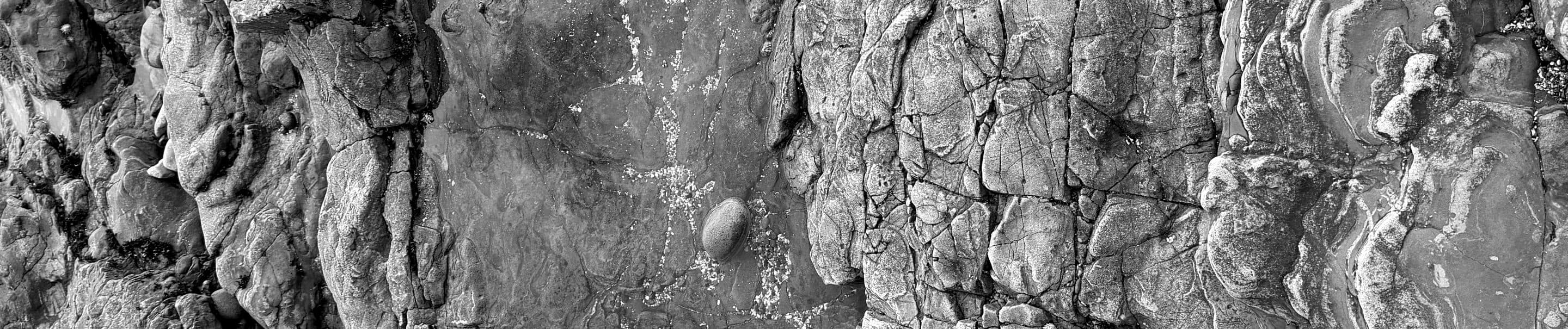 A fissure through layered rock, black and white